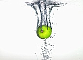 A lime falling into water