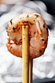 A herb prawn with chopsticks