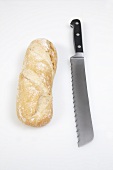A white baguette and a bread knife