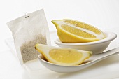 A lemon wedge, half a lemon and a tea bag