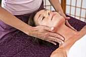 A woman having a face massage in a spa