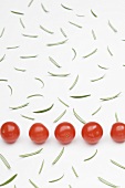 Cherry tomatoes and scattered rosemary leaves
