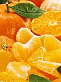 Mandarins, whole, halved and segments (close-up)