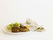 Crab Cakes with Side Salad on a Plate; Cloth Napkin