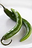 Two green chilli peppers