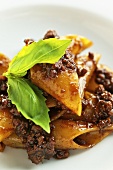 Penne with salsiccia sausage and basil (close-up)