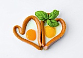 Two sausage and fried egg hearts