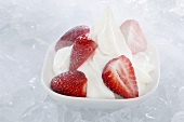 Yogurt ice cream, garnished with fresh strawberries