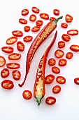 A red chilli, halved surrounded by chilli rings