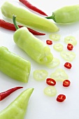 Pointed peppers and red chilli peppers, partially sliced