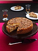 Praline cheese cake on a cake platter with a pie slice