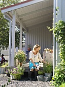 Woman sitting on veranda in garden