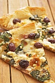 Two Slices of Greek Style Pizza with Kalamata Olives, Feta Cheese and Spinach