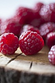 Raspberries on a wooden surface (close-up)
