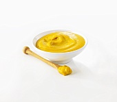 Mustard in small pot and on spoon