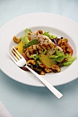 Grilled chicken fillets with citrus fruits, lettuce and cashew nuts