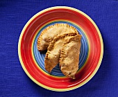 Beef Filled Pastries on a Colorful Plate; From Above