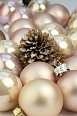 Pink Christmas baubles and a pine cone