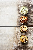 Barbecue Side Dishes in Small Bowls on a Wooden Table; Pork and Beans, Potato Salad, Cole Slaw and Succotash
