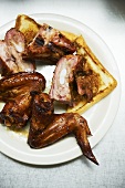 Pieces of Barbecue Chicken with Toast on a White Plate