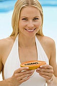 A woman holding a papaya