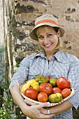 Woman with bowl of tomatoes