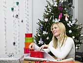 A woman wrapping Christmas gifts