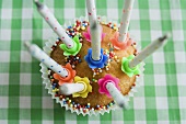 A cupcake with birthday candles