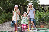 Three girls gardening in vegetable garden