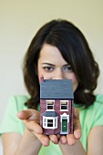 Woman holding a house