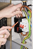 An electrician fixing a fuse box