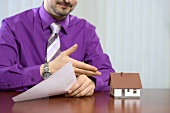 Estate agent with model house