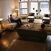 A man and a woman sitting in a living room