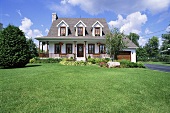 A lawn in front of a large house