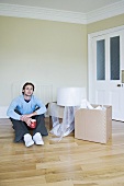 A man in a room with cardboard boxes