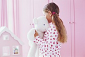 Girl hugging her teddy bear