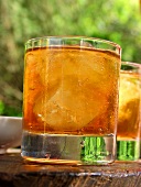 Two glasses of iced tea on table in open air