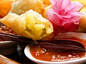 Fried pastries with potato filling and spicy sauce