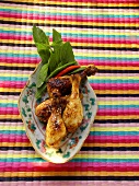 Asian chicken legs with sesame on platter