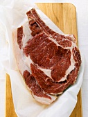Ribeye steak on chopping board