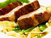 Roast pork with noodles, beans and peas