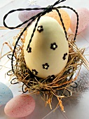 White chocolate egg in Easter nest