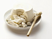 Ricotta on plate with kitchen spoon