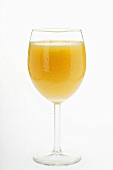 Cold orange juice in stemmed glass