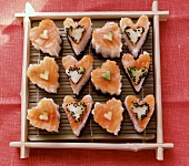 Heart-shaped sushi with salmon, cucumber and sesame
