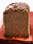 Wholemeal bread with oat flakes on red napkin