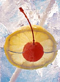 Drink with slice of lemon and cocktail cherry (close-up)