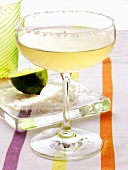 Lime cocktail in a champagne glass with sugared rim; lime