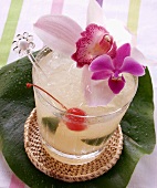Caribbean drink with lime on banana leaf