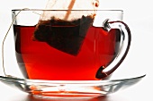 Hibiscus tea in glass cup with tea bag